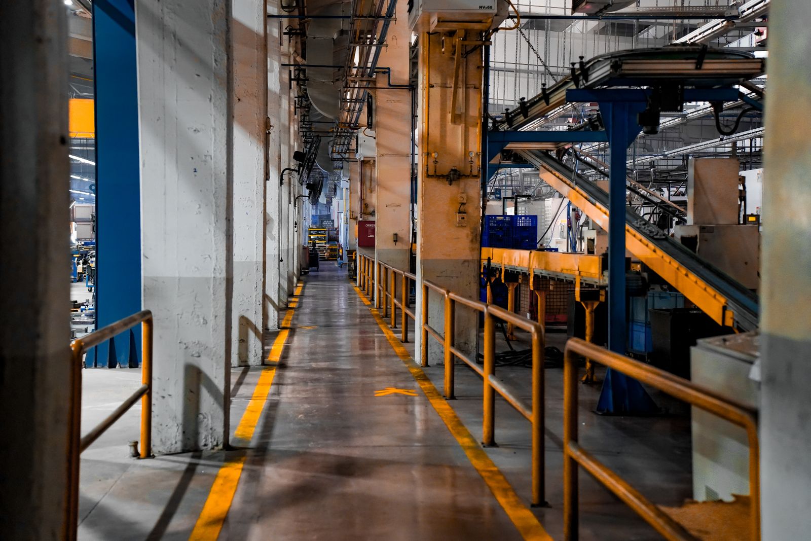Industrial manufacturing facility interior with production machinery and conveyor