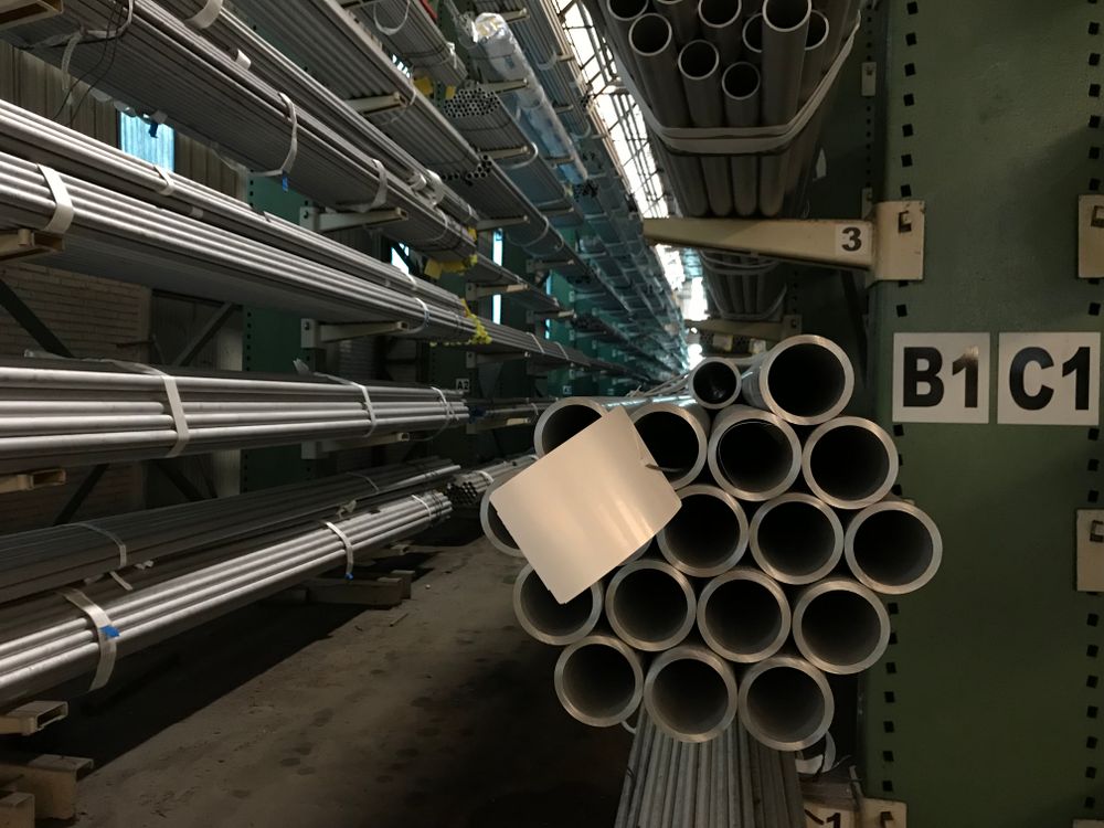 Industrial warehouse with stacked steel and metal raw materials